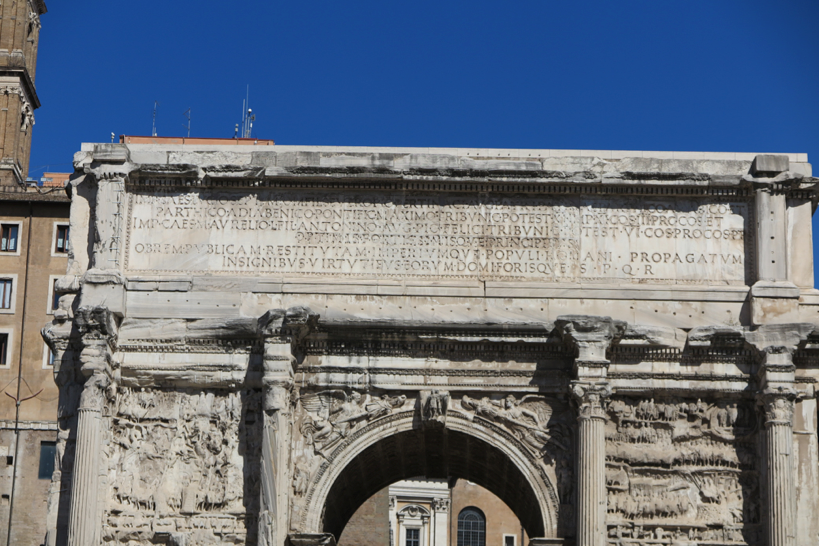 engraved text is written on the entrance of a ruined building