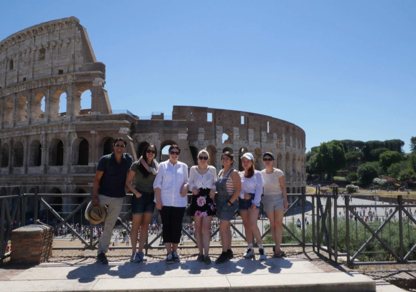 group photo of students in front of the colosseum