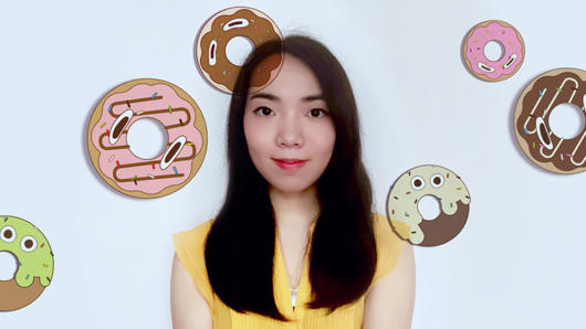 A photo of a girl wearing a yellow dress. Over the photo there are cartoon images of personified donuts.