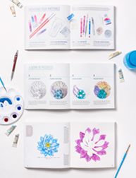 A set of three opened notebooks with sample color designs of flowers and other objects.