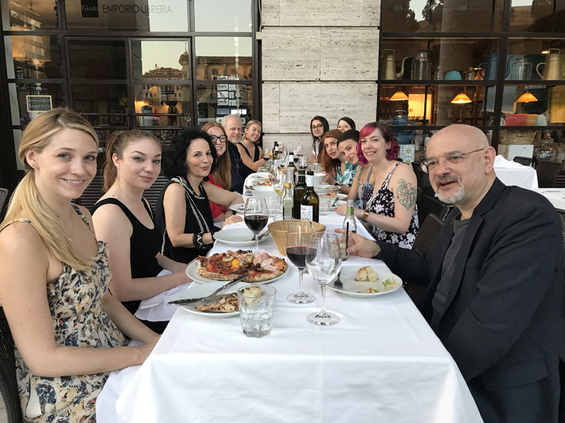 A photo of a group of people sitting at a restaurant table.