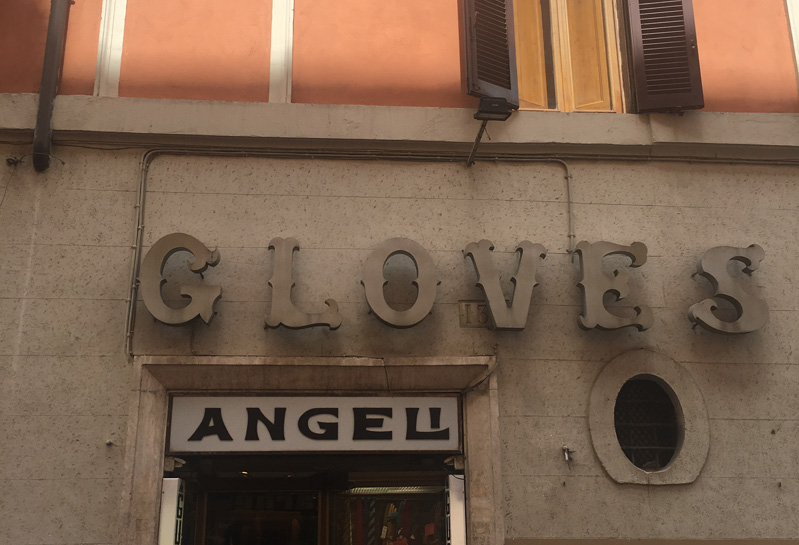 A photo of a shop entrance with text logo: Glove S Angeli.