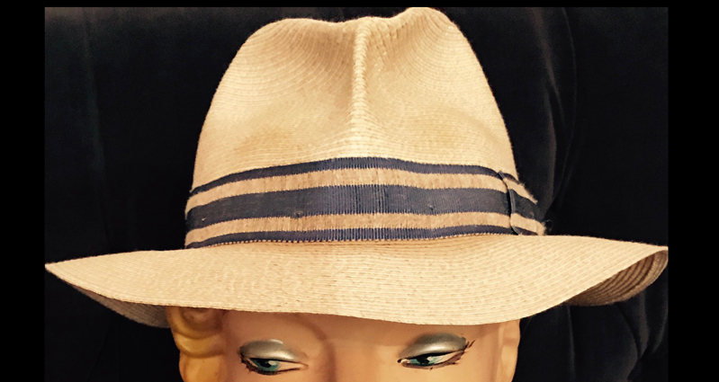 A photo of a white hat on a plastic female head.