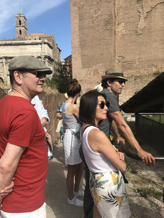A photo of a group of people visiting some ancient ruins in Rome.