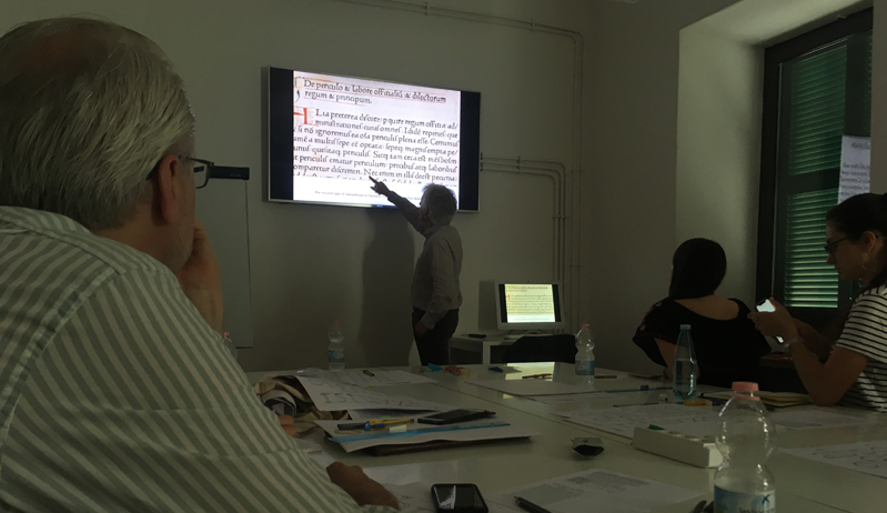 A photo from a lecture session where different text characters are being presented.