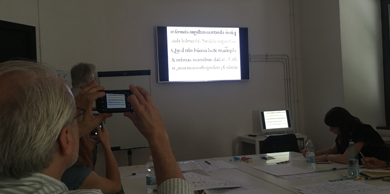 A photo from a lecture session where different text characters are being presented.