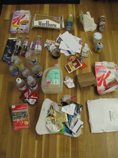 An image depicting cereal boxes, different plastic bottles, paper, envelopes, soda cans and other food packaging remains.