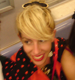 Photograph of a blond woman smiling.