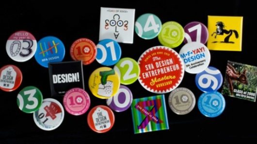 A photo of some multicolored vote buttons with numbers on them One pin has the text: SVA Design Entrepreneur Masters Class.