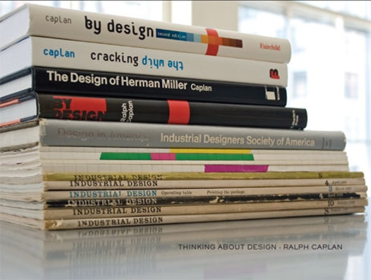 A stack of design books and sketchbooks.