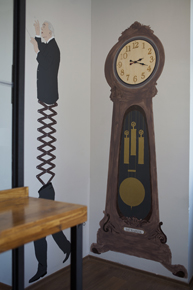A photo of two drawings, one of them is a man split by  and the other is an old closet clock.
