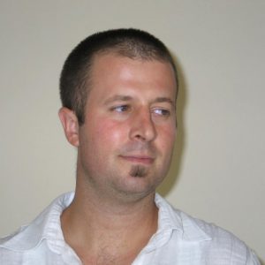 A photo of a man wearing a white shirt.