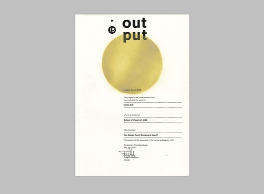 A piece of paper with a yellow ball printed on it, some text and a signature. The title for the paper is: Out Put 15.