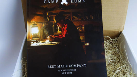 A book cover with a man sitting at a desk near a lamp. The title of the book: CAMP X HOME Best Made Company.