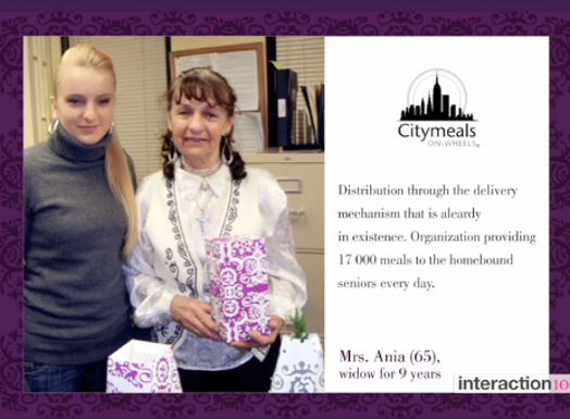 A card with a photo of two women, one holding a box with violet patterns on it. On the side a text and a logo of Citymeals.