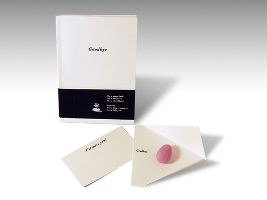 A book design and some envelopes with a pink egglike shape on one of them.