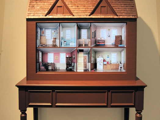 A photo of a cabinet that looks like a doll house.