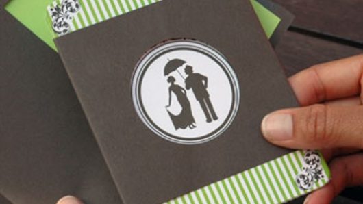 A card invitation designed colored in green stripes and in the middle a circle with a man an a woman figure.
