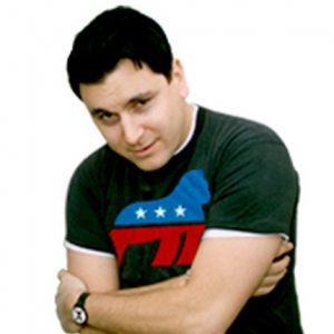 A photo of a man wearing a watch and a black t shirt with a campaign logo on it.