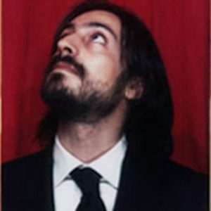 A photo of a man wearing a suit and looking up.