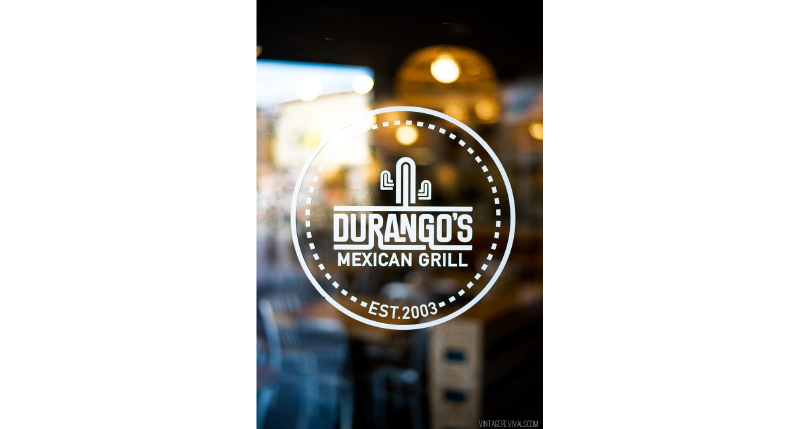 A white logo on a store glass which shows a cactus and the text: Durango's Mexican Grill.
