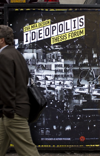A photo of a man walking by a black and white poster of SVA MFA DESIGN IDEOPOLIS THESIS FORUM.