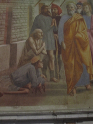 A photo of a fresco depicting a group of people in the street.
