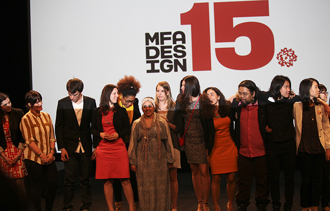 A photo of a group of people on the stage while behind them there is a SVA logo of MFA DESIGN 15.
