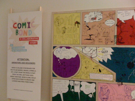 A photo of a comic book sketch on a board. The text Comic Bond A Collaborative Story is on the side.