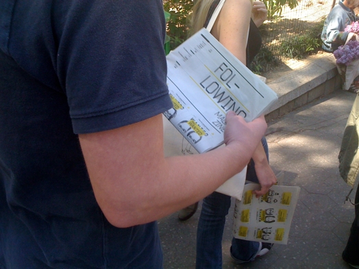 A photo of a man and a girl holding some fliers.