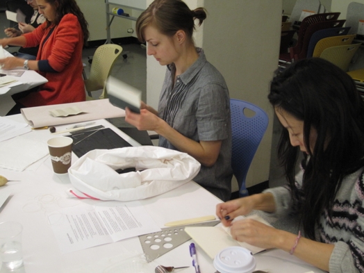 A photo of some students working with paper.