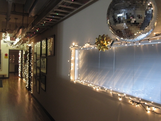 A photo of a room filled with light strips while a disco ball is hanged from the ceiling.