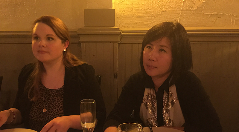 A photo of two women sitting at a restaurant table.