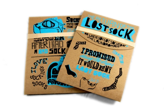 A cardboard sketch art design of packages for socks. The title on the pack: The return of the lost sock.