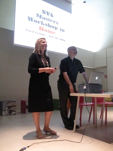 A photo of two people giving a lecture with the title: SVA Masters Workshop in Rome, projected on a screen.