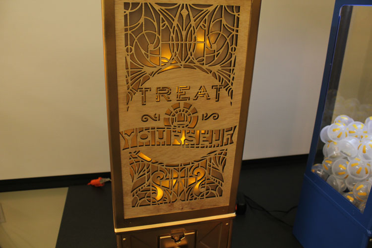 An engraved plywood with text: Treat Yourself.