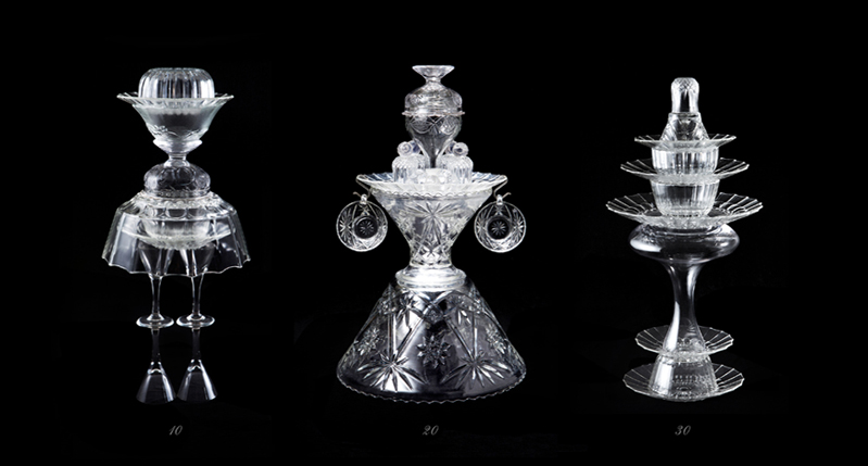 A photo of three glass objects that look like figurines.