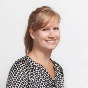 A photo of a woman wearing a black and white blouse.