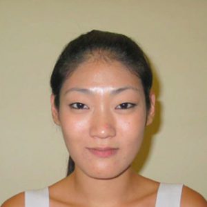 A photo of a woman wearing a white dress.