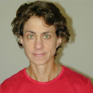 A photo of a smiling woman wearing a red shirt.