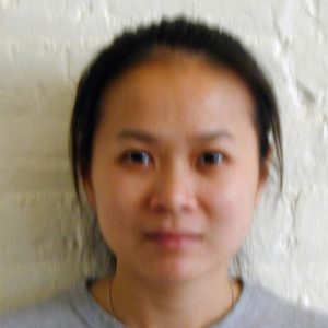 A photo of a woman wearing a gray shirt.
