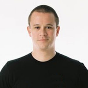 A photo of a man wearing a black blouse.
