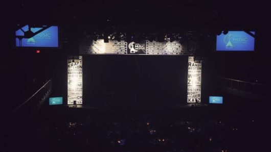 A photo of a stage with illuminated margins that look like newspaper clippings.