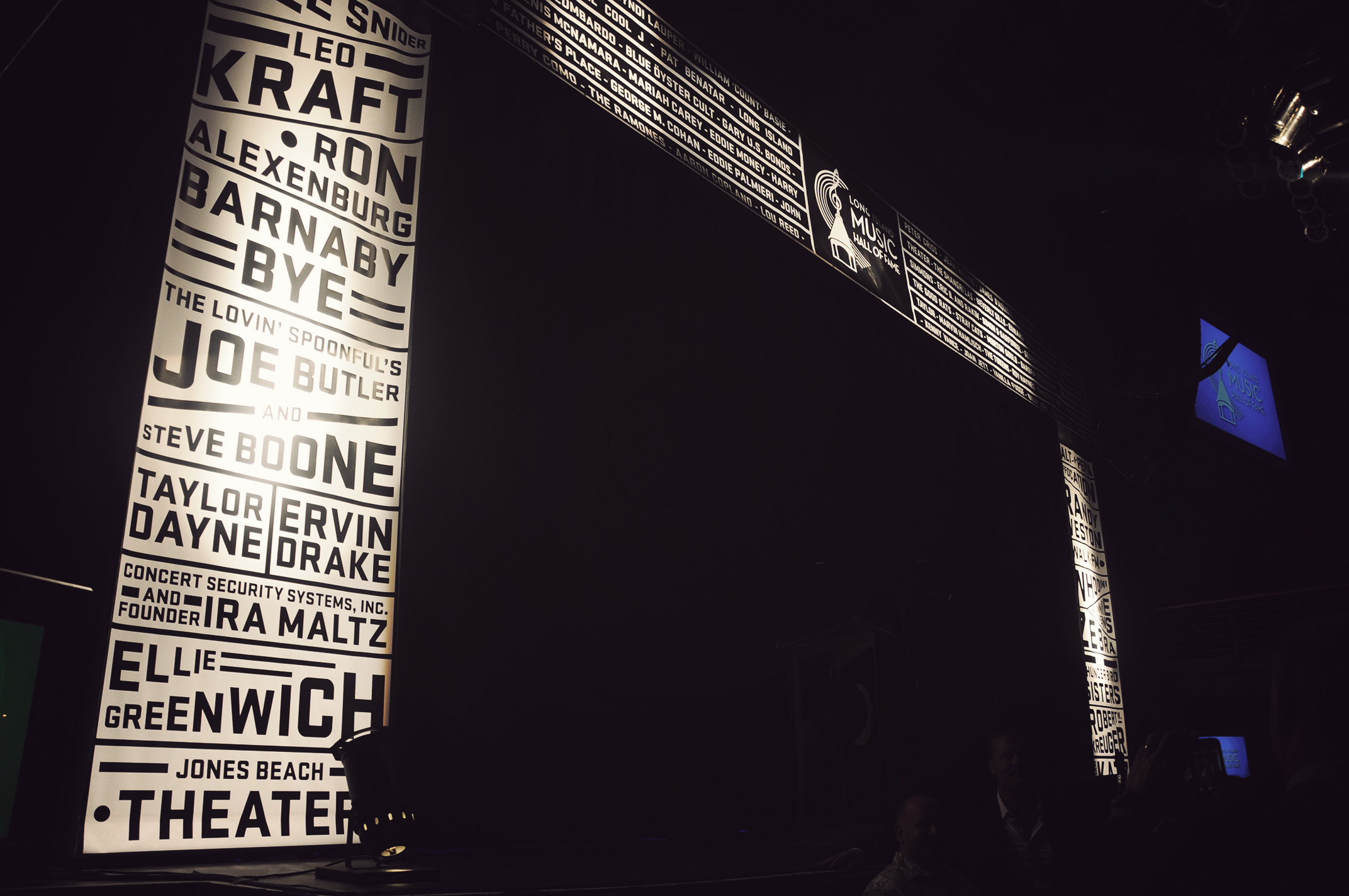 A photo of a stage with illuminated margins that look like newspaper clippings.