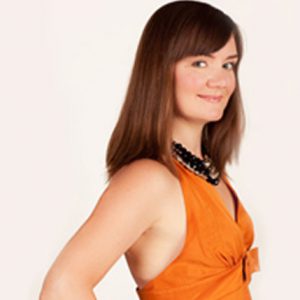 A photo of a woman wearing an orange dress.
