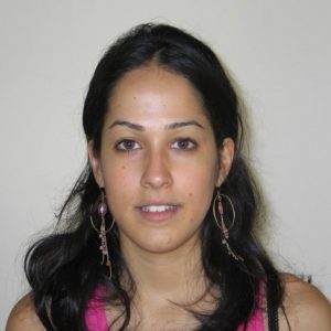A photo of a woman wearing a pink undershirt.