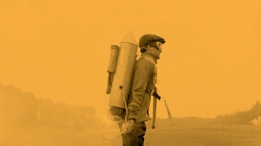 An orange poster showing a photo of a man with a rocket pack strapped on him while trying to take off the ground. The title: Julie Lasky.