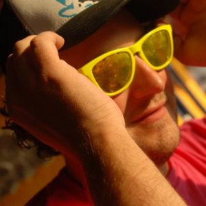 A man wearing sunglasses and a cap.