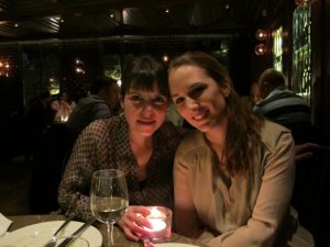 A photo of two women sitting at a restaurant table.