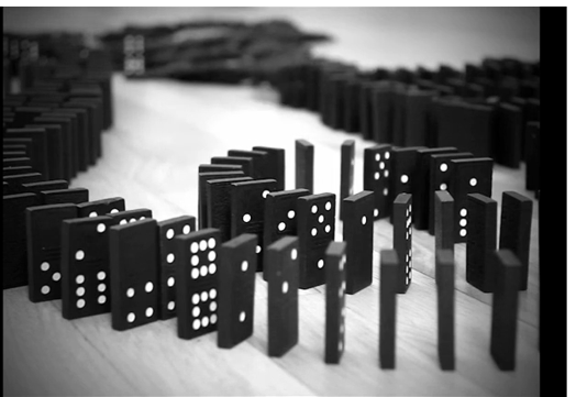 A black and white photo of a domino game tiles.
